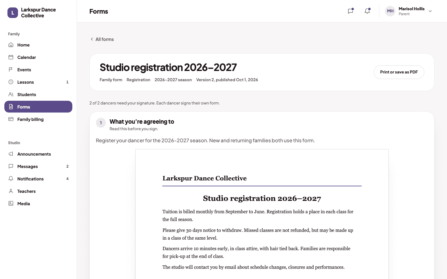 A parent reading the studio registration form before signing it